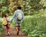 6 Fun, Meaningful SEL Activities to Help Girls Develop Confidence and Advocacy Skills Back view of joyful mother and daughter walking on nature trail